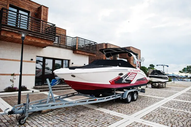 Motor boat on a trailer for road transport — boat as cargo