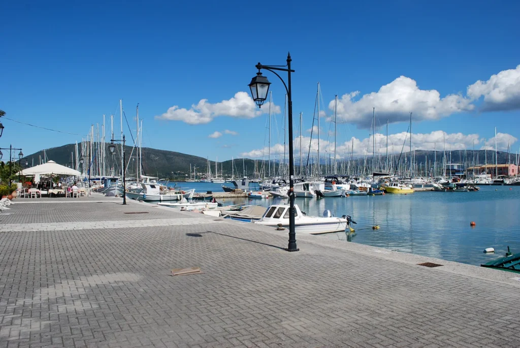 Charter yachts moored along the quay of a marina in Lefkada, Greece