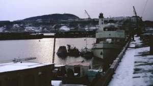 Boats moored in a snow-covered harbour in winter