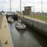 Sailing yachts in the lock at Kornwerderzand on the Afsluitdijk, Netherlands
