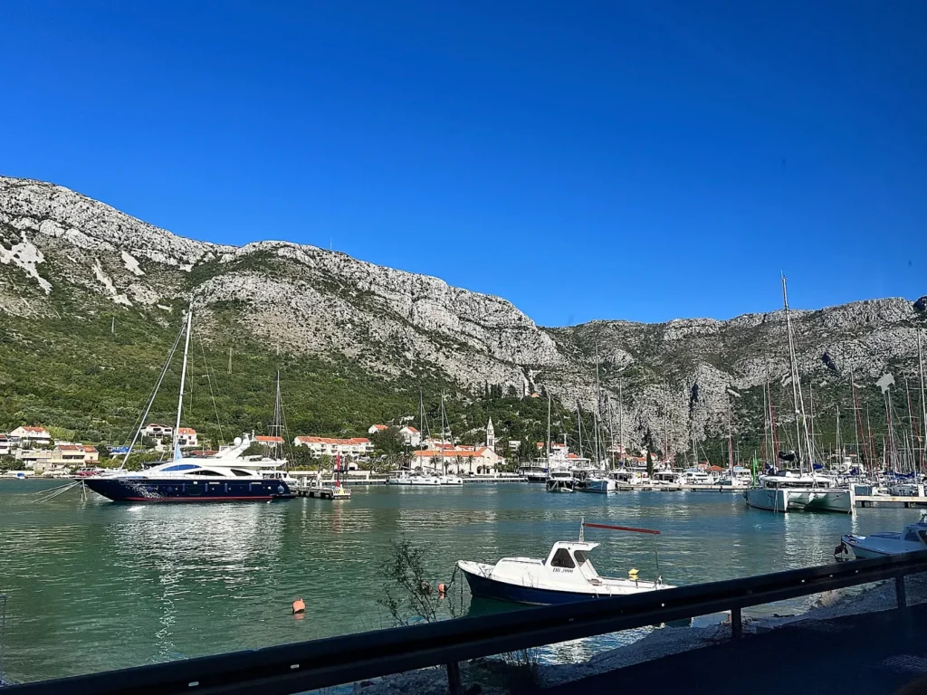 Yachts in a marina near Dubrovnik, Croatia, below limestone mountains