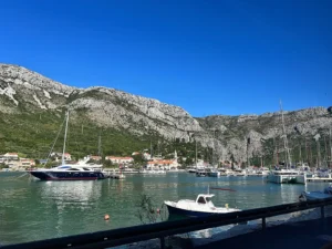 Yachts in a marina near Dubrovnik, Croatia, below limestone mountains