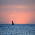 Sailing yacht at sea at dusk as the night watch begins