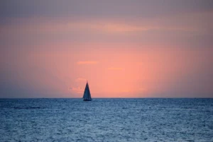 Sailing yacht at sea at dusk as the night watch begins
