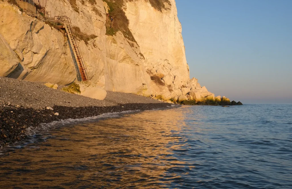 White chalk cliffs of Dover above a calm English Channel at sunset
