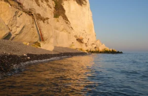 White chalk cliffs of Dover above a calm English Channel at sunset