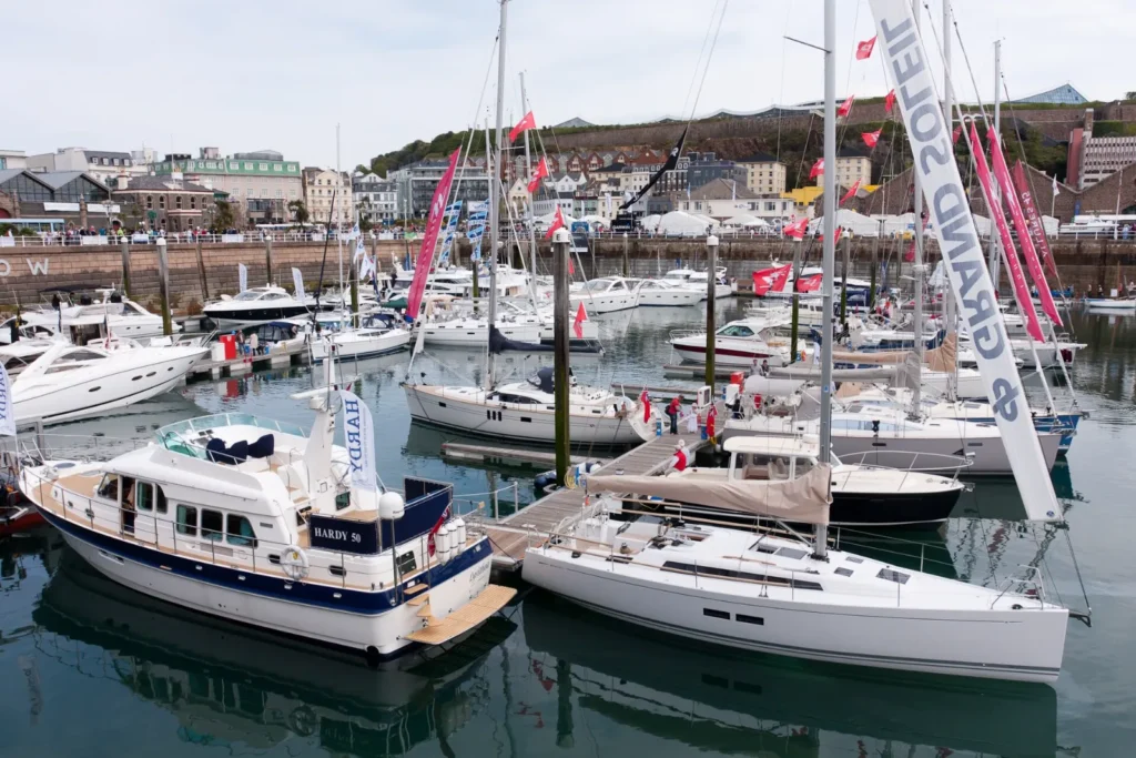Sailing and motor yachts on display at a boat show marina