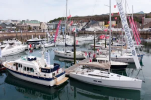 Sailing and motor yachts on display at a boat show marina